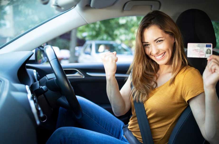 Happy learner driver celebrating after passing their practical driving test
