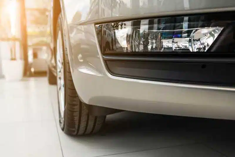 Front fog light fitted low in the front bumper of a car