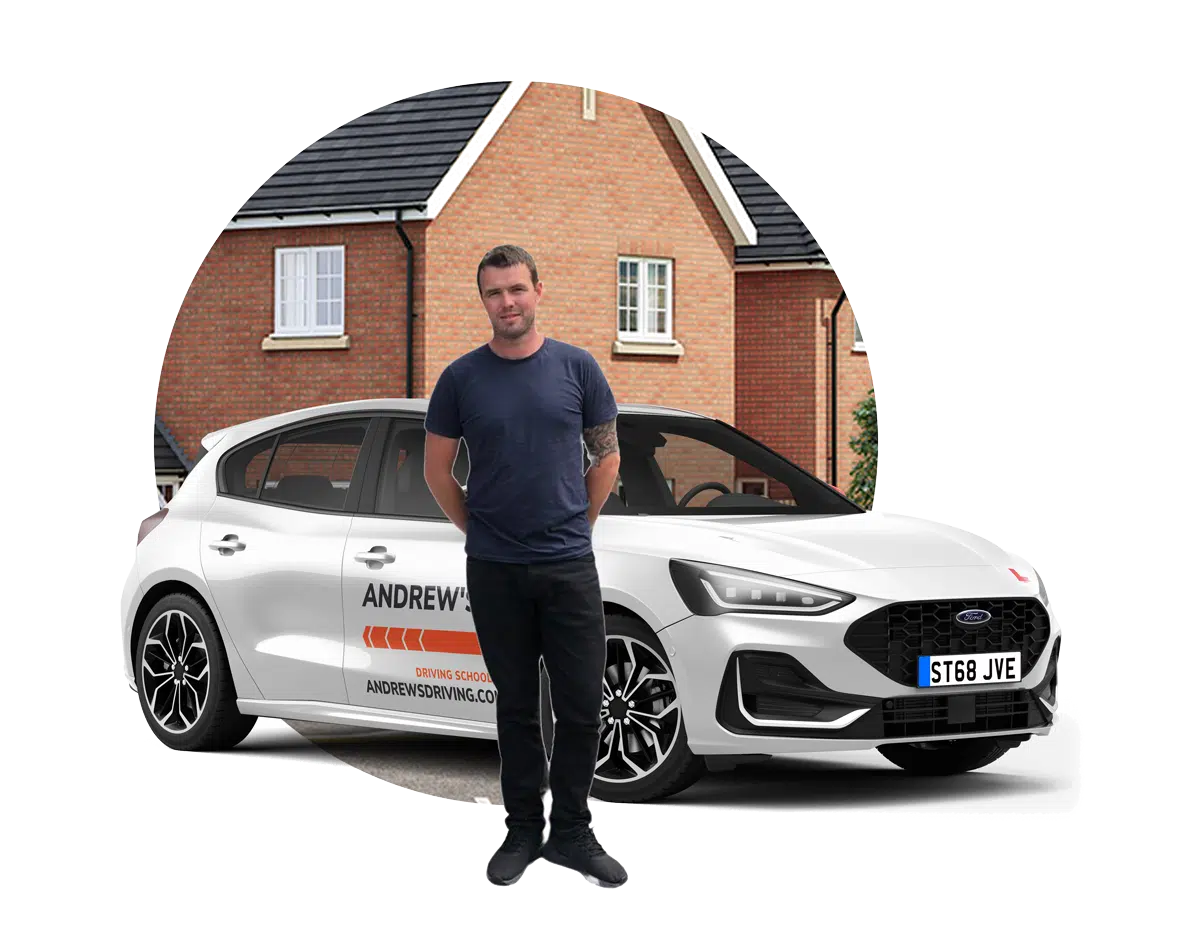 Driving instructor trainer beside an Andrew's Driving School tuition car