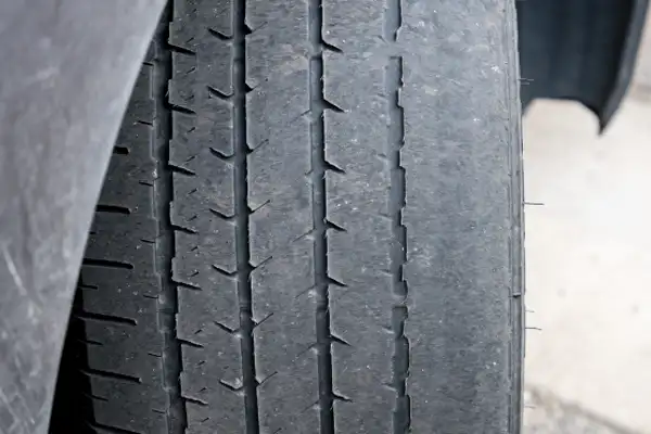 Worn car tyre showing very low tread depth