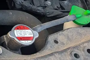 Suzuki Swift coolant reservoir inside the engine bay