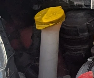 Toyota Yaris 1.5 Hybrid screen wash reservoir filler inside the engine bay