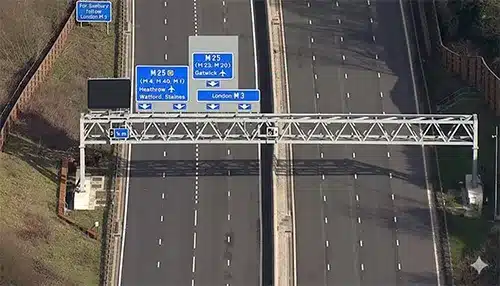 Smart motorway viewed from above showing traffic lanes and overhead gantries