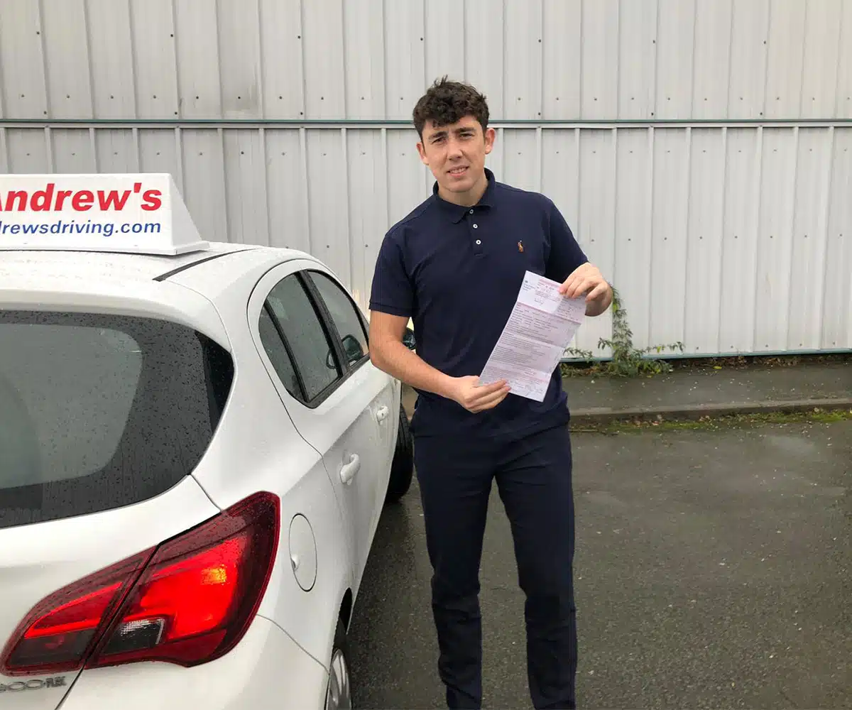 Alex at Bangor Driving Test Centre holding his ADI Part 3 pass certificate
