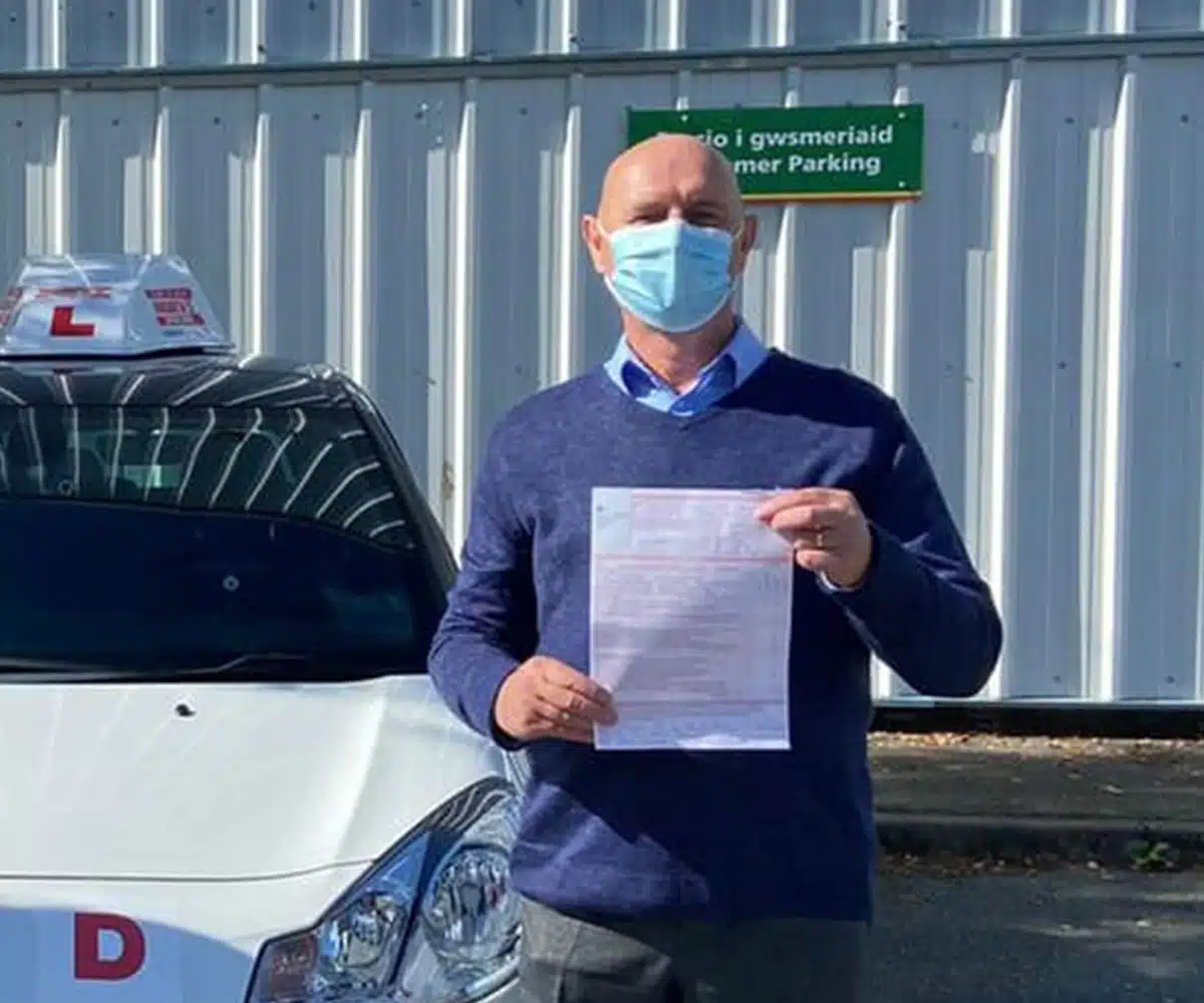 Gwyn Parry holding his ADI Part 3 pass assessment