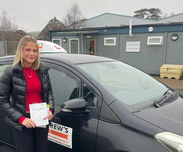 Lucy outside Bangor Driving Test Centre with her pass certificate