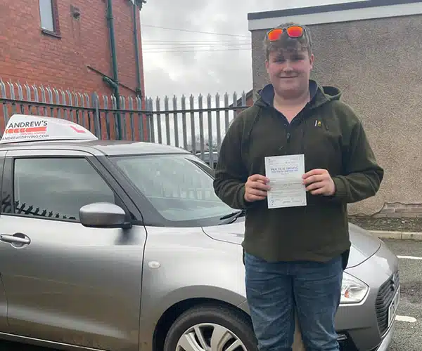 "Luke next to Ursulas Andrew's Driving School car in the Rhyl Test Centre"