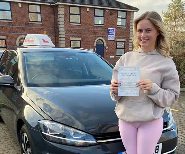 Maddie showing off her new pass certificate outside Chester Driving Test Centre