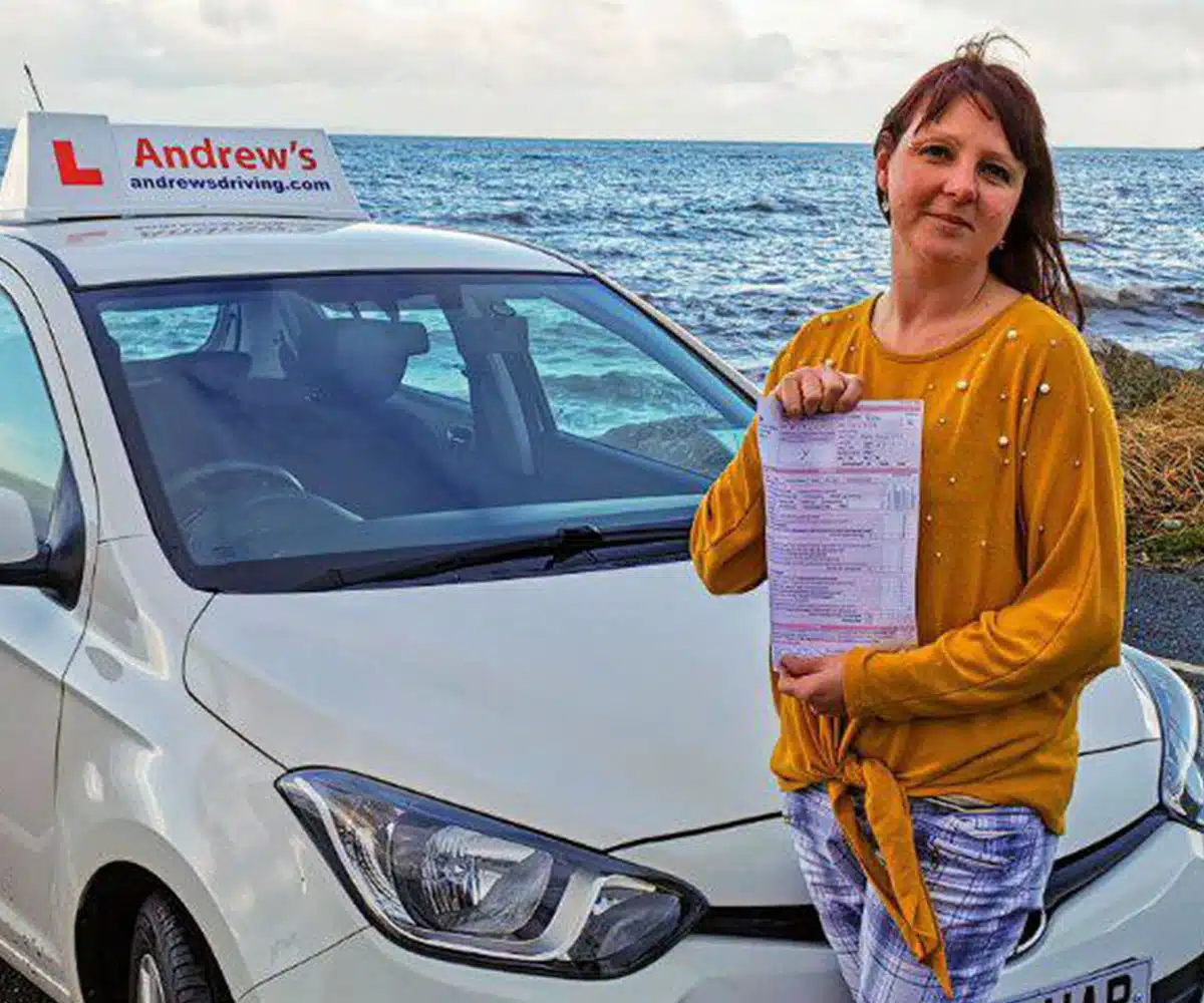 Maria Taylor holding her ADI Part 3 pass certificate
