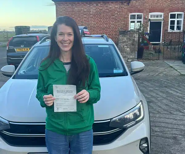 Sarah celebrating a driving test pass in Rhyl with Andrew's Driving School