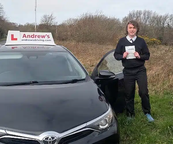 Arthur Jones from Conwy holding his pass certificacar after his test in Bangor Driving Test Centre.
