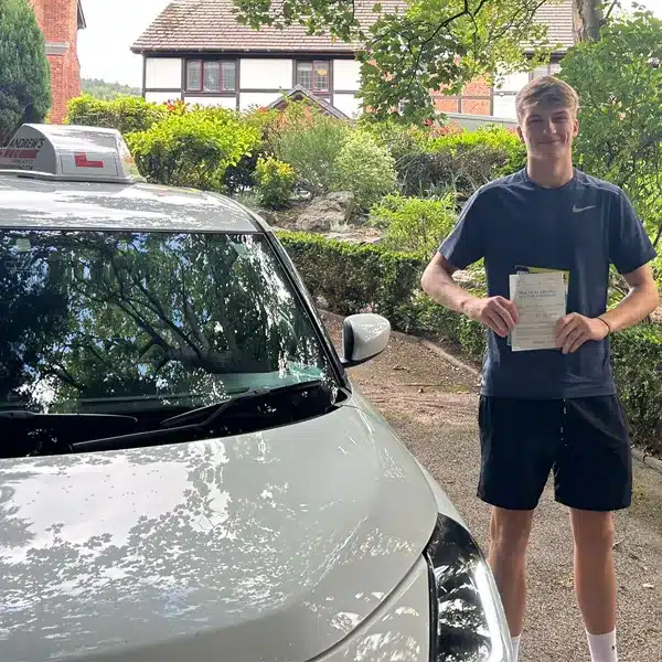 Austin celebrating after passing his driving test in Colwyn Bay