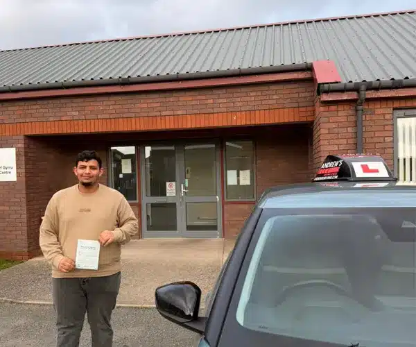 Baseer outside Rhyl Test Centre with his pass certificate