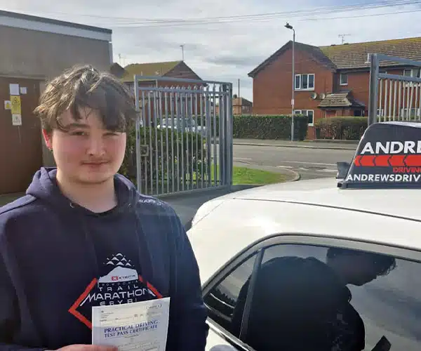 Iori holding a practical driving test pass certifientre after passing with instructor Paul Sanders.
