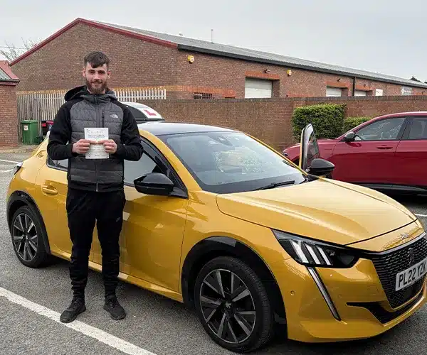 Young man in Rhyl Test Centre with his pass certificate