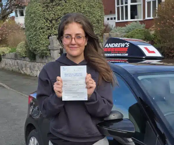 Lillie celebrating a driving test pass in Rhyl with Andrew's Driving School