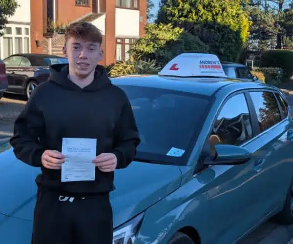 "Max standing next to Jack's car with his driving test pass certificate"