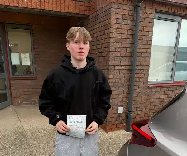 Theo outside the main door of Rhyl Driving Test Centre