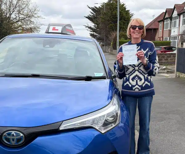 Alison celebrating automatic driving test pass aftiving lessons in Rhyl with local instructor Fiona