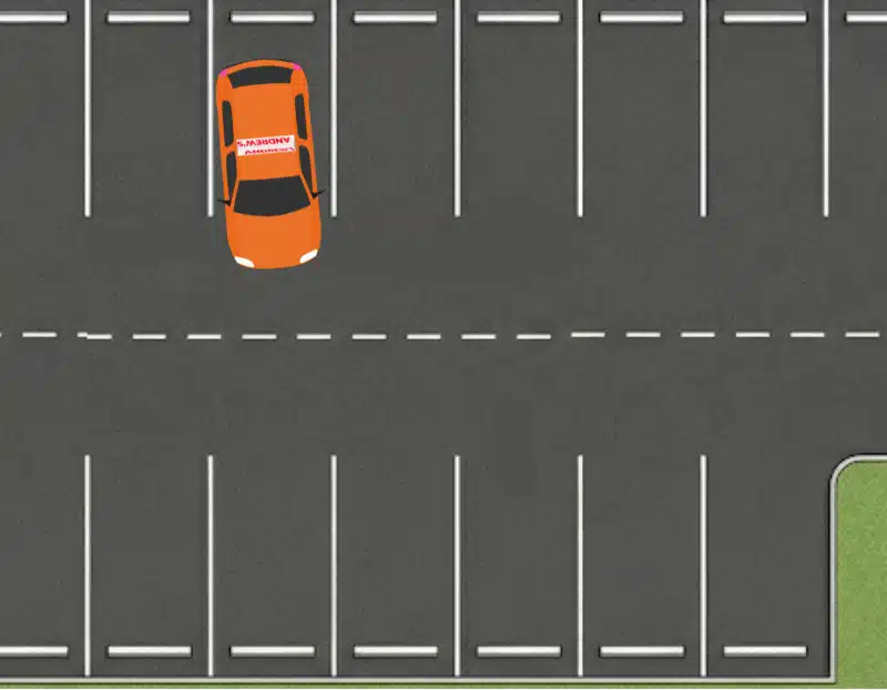 Orange learner car almost straight inside a marked parking bay