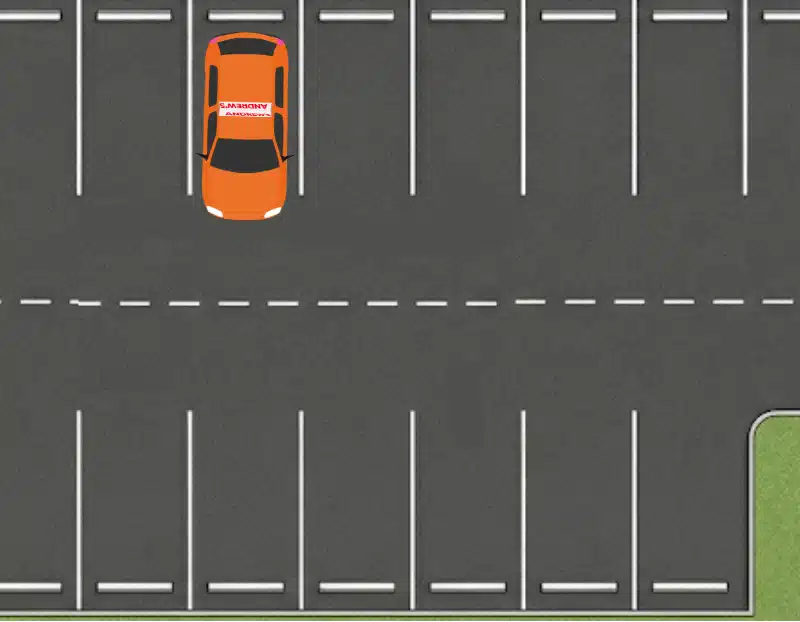 Orange learner car fully parked and centred inside a parking bay
