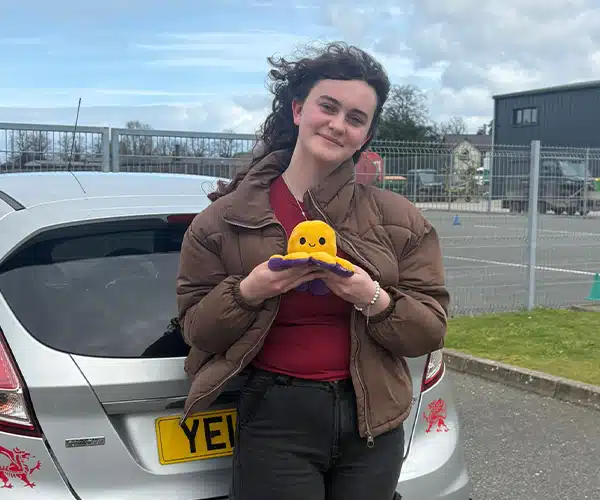 Casey from Anglesey in Bangor Driving Test Centre smiling after passing her driving test first time