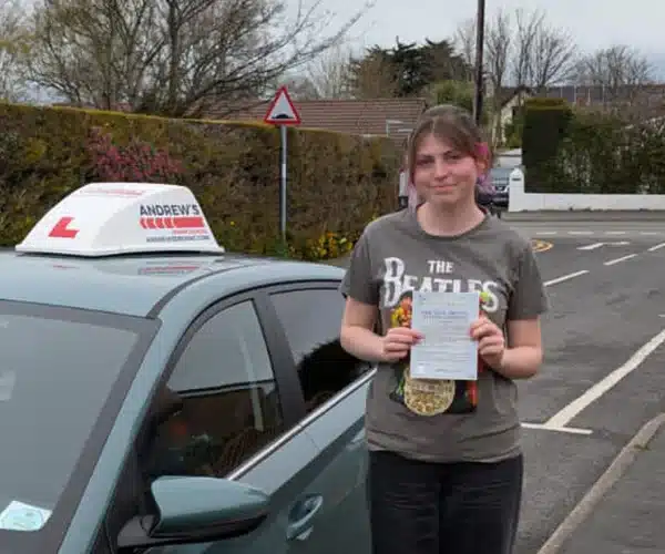 Jessica holding her practical driving test pass cecar in Colwyn Bay after passing her test in Rhyl.