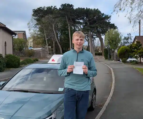Matt celebrating a driving test pass in Rhyl with Andrew's Driving School