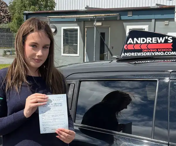Abi celebrates passing her driving test in Bangor after driving lessons in Anglesey with Llinos Begley from Andrew's Driving School.