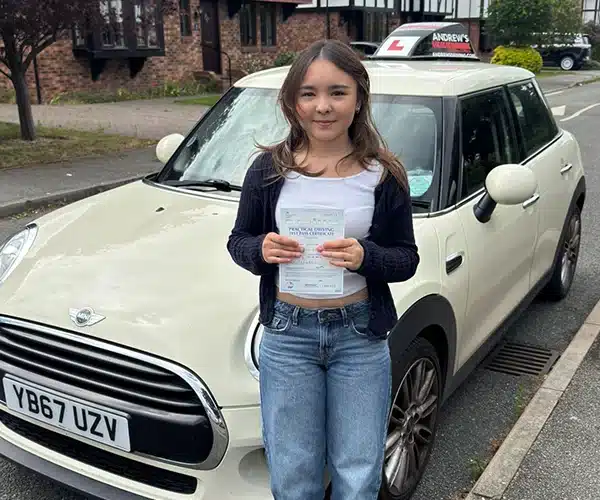 Christina celebrates passing her automatic driving test in Rhyl with Andrew's Driving School.