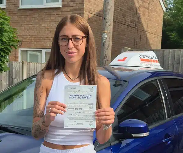 Courtney celebrates passing her driving test in Wrexham with Andrew's Driving School.