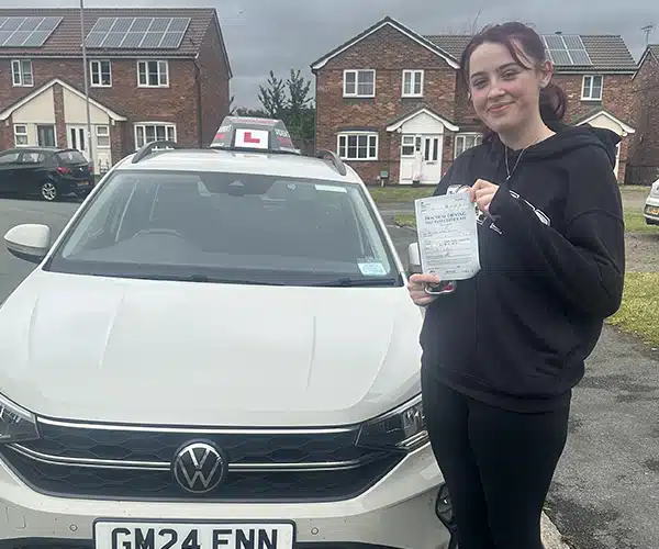 Francheska from Denbigh celebrates passing her driving test in Rhyl with instructor Paul Singleton from Andrew's Driving School.