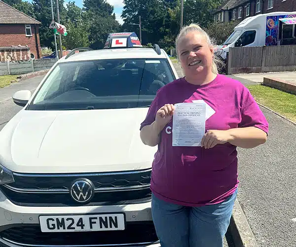 Hayley celebrates passing her driving test with Andrew's Driving School.