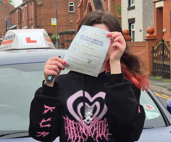Isobel Clayton celebrates passing her driving test in Wrexham with instructor Craig Hughes from Andrew's Driving School.