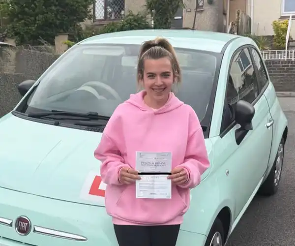 Kaitlyn from Llandudno celebrates passing her driving test in Rhyl with instructor Ben Vaughan-Jones from Andrew's Driving School.