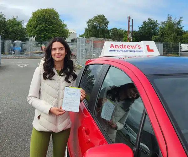 Layla from Colwyn Bay celebrates passing her automatic driving test first time in Bangor with instructor Claire from Andrew's Driving School.