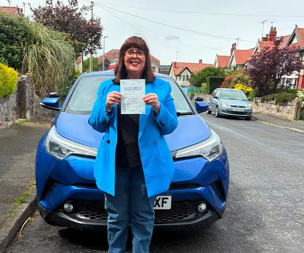 Lindsay celebrates passing an automatic driving test in Rhyl with Andrew's Driving School.