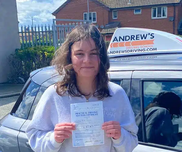 Lucy from Colwyn Bay celebrates passing her driving test in Rhyl with instructor Andy Kirkham from Andrew's Driving School.