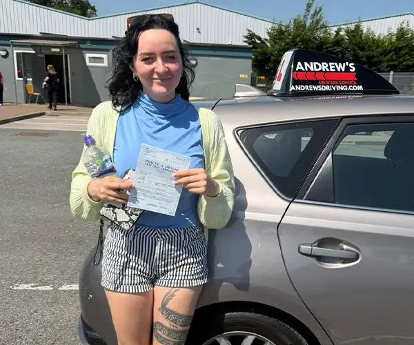 Marta celebrates passing her driving test in Rhyl with instructor Ursula from Andrew's Driving School.