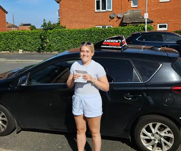 Mia Simon celebrates passing her driving test with instructor Darren from Andrew's Driving School.