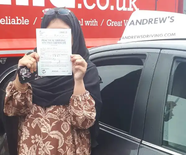 Naz celebrates passing an automatic driving test in Rhyl with instructor Barry Evans from Andrew's Driving School.