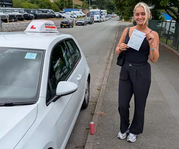 Rhiannon Williams celebrates passing her driving test in Rhyl with instructor Tomas from Andrew's Driving School.