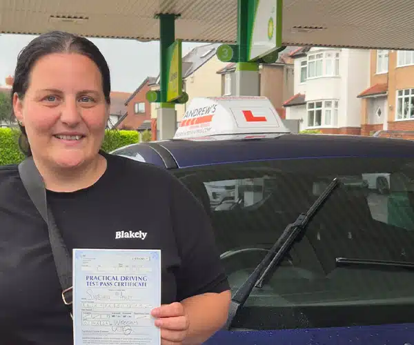 Siobhan celebrates passing her driving test in Wrexham with Andrew's Driving School.
