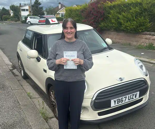 Tracy celebrates passing her driving test in Rhyl with Andrew's Driving School.